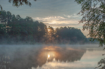 Sunrise on the lake in the forest.
