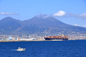 July 11 2021 Napoli in Italy in Europe: A picture of the city of Naples with a cargo ship in the gulf.