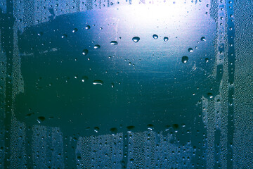 Drops on the glass in blue light