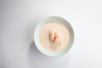 Cream coconut soup with salmon and shrimp isolated on white background