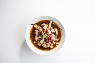 Fish soup with herbs and chili pepper asian food isolated on white background