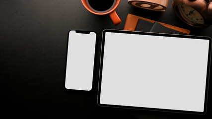 Mock up digital tablet and smartphone on modern black working table