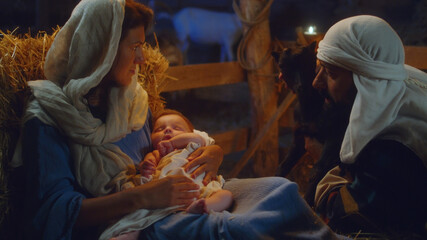 Joseph with lamb near Mary and baby Jesus