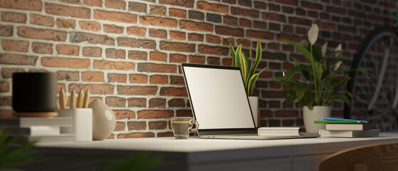 Side view, Loft apartment with brick wall, work station with laptop blank screen mockup