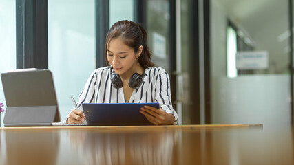 female employee learning on online training program, working at office