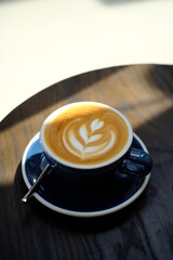 Awesome Latte art hot coffee drink  on wooden table in coffee shop cafe