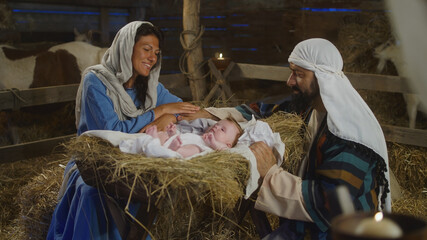 Mary and Joseph speaking and taking care of baby Jesus