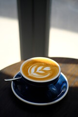 Awesome Latte art hot coffee drink on wooden table in coffee shop cafe