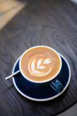 Awesome Latte art hot coffee drink  on wooden table in coffee shop cafe