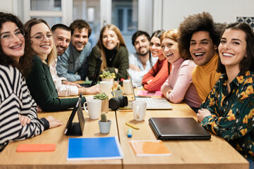 Group of young coworker team having fun working inside modern startup office - Focus on african man face