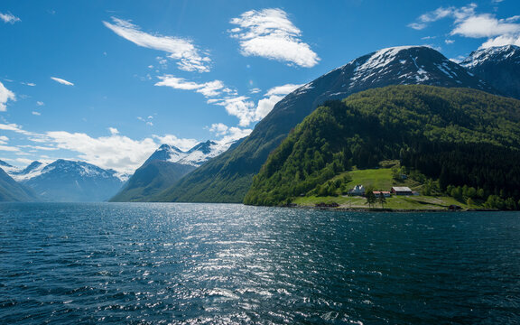 Norwegian fjord with blue skies and houses on grass copy space negative space no people
