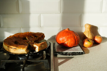 Still life of autumn fruits and and crumble pie on table with shadows