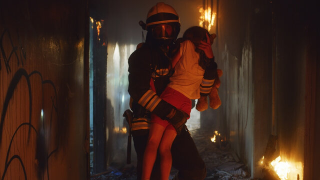 Fireman carrying kid heroically through smoke and fire