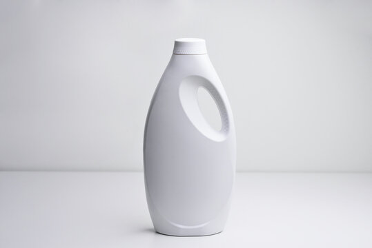 White plastic bottle for liquid laundry detergent, cleaning agent, bleach or fabric softener. Package mockup. Packaging, a bottle template for detergents and chemicals with a lid. 