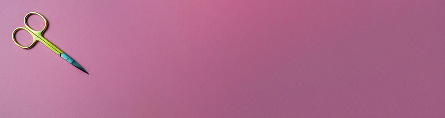 manicure scissors on a pink background. scissors close up. banner for insertion on the site