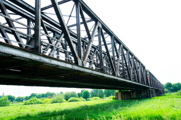 Railway bridge near Hagenohsen, Lower Saxony. Steel construction of a bridge with green nature in the area.