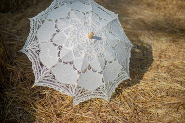 white umbrella spread on straw