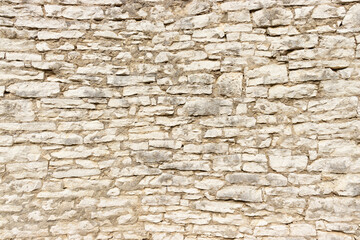 Large stone wall made by stacking small stone blocks