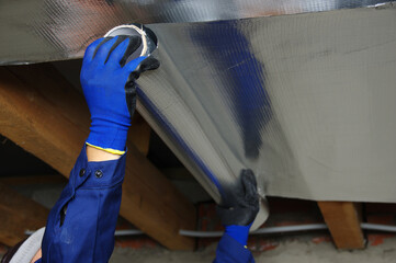 Builder attaches vapor barrier membrane