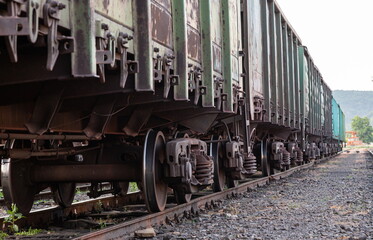Fototapeta na wymiar Old rusty railway cars stand on the tracks of the station