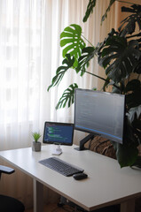 Fototapeta premium Work place for developer with curved screen and tablet.Comfort working from home