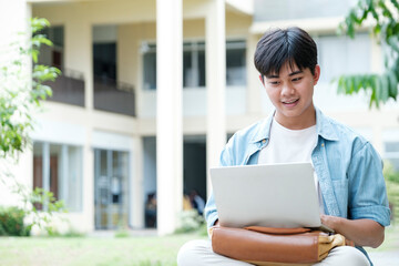 Young collage student using computer and mobile device studying online.