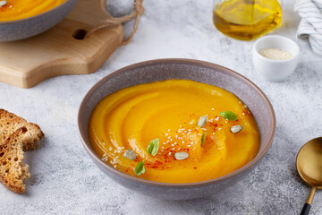 Pumpkin puree soup, served in a wide plate