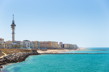 Beautiful "Santa Maria del Mar" Beach situated in Cadiz city. Panoramic view over the city. View of Torre Tavira II - El Pirulí and promenade area of Cadiz.