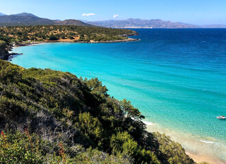 Fototapeta na wymiar Golden sand and clear water at Voulisma beach on Crete island in Greece