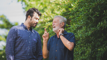 Adult hipster son and old senior father stay for work at home, two generations have a beard talking together and relaxing with smile, happy enjoy living to isolation quarantine at home, father's day - obrazy, fototapety, plakaty