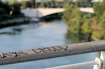 top river view through a bridge fence written