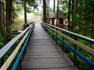 Obraz premium Dovsk, BELARUS - JUNE 24, 2021: Holy Trinity Krynitsa holy place with spring water in the forest