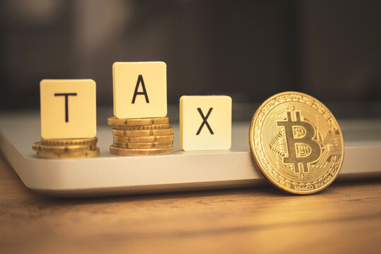 TAX with cryptocurrency bitcoin. Digital banking and revenue with golden bitcoin. Desktop with laptop, business photo