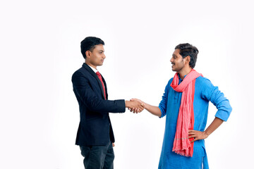 Financial adviser shaking hands with a farmer at office