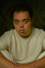 Portrait of young man with Down Syndrome looking into the camera