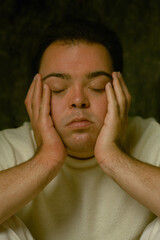 Portrait of young man with Down Syndrome with closed eyes
