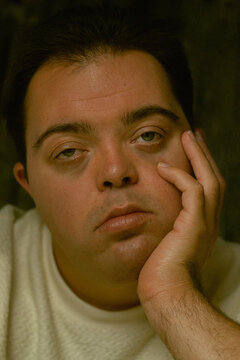 Closeup portrait of young man with Down Syndrome looking into the camera