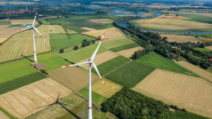 Aerial view of wind turbines windmills in farming fields. Alternative ecological energy production...
