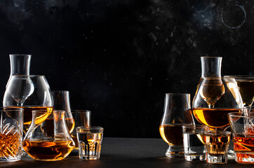 Strong alcoholic drinks, spirits and distillates iset in glasses: cognac, scotch, whiskey and...