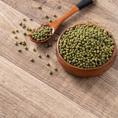 Close up of raw mung bean on wooden table background.