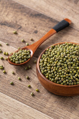 Close up of raw mung bean on wooden table background.