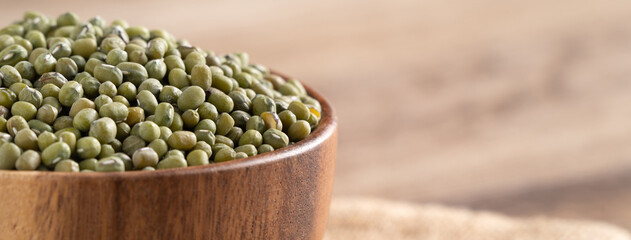 Close up of raw mung bean on wooden table background.