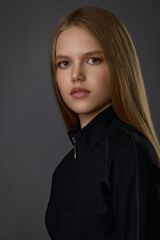 Fototapeta premium Portrait of a young blonde girl in black clothes 