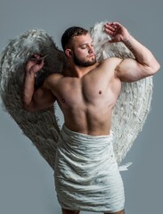 athletic guy with strong muscles in cupid angel wings, valentines day
