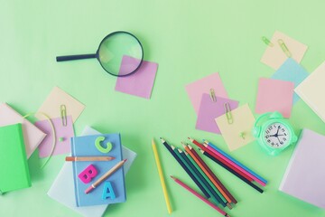 Books and stationery on bright background, top view, flat ley, back to school concept, education