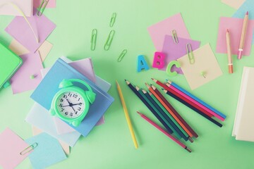 Books and stationery on bright background, top view, flat ley, back to school concept, education