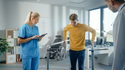 Hospital Physical Therapy: Determined Male Patient with Injury Successfully Walks Holding Parallel Bars. Physiotherapist, Rehabilitation Doctor Encourage, Applaud Disabled Person.