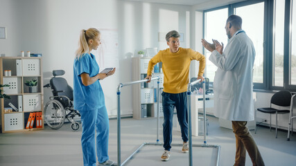 Hospital Physical Therapy: Strong Determined Male Patient with Injury Successfully Walks Holding Parallel Bars. Physiotherapist, Rehabilitation Doctor, Help, Assist, Encourage Disabled Person to Heal