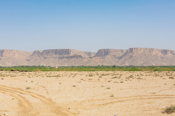 scenery of vast wilderness, rocky mountains, and blue sky in hadramaut, yemen