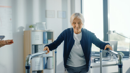 Hospital Physical Therapy: Portrait of Strong Senior Female Patient with Injury Successfully Walks Holding Parallel Bars. Physiotherapist, Rehabilitation Doctor, Help, Assist Disabled Patient